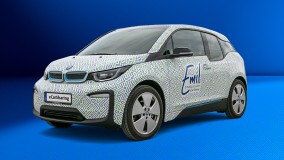 BMW i3 mit Emil eCarSharing-Branding und grün-blauem Muster.